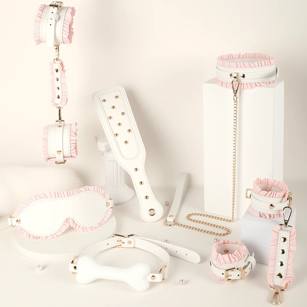 White Maid Bondage Restraint Set Bondage Restraint Set with white maid-inspired cuffs, collar, blindfold, chain detail, and ruffle accents